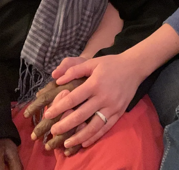 Two hands clasped together